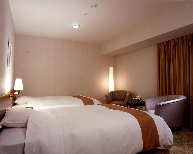 Postel nebo postele na pokoji v ubytování Keisei Hotel Miramare
