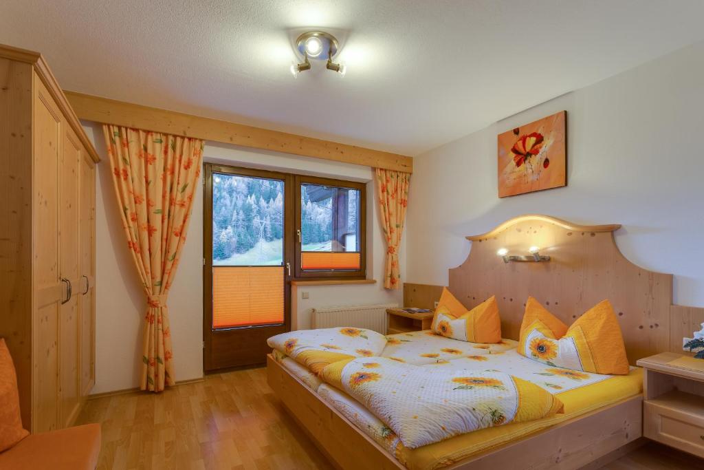 a bedroom with a bed and a window at Haus Berthold in Sölden