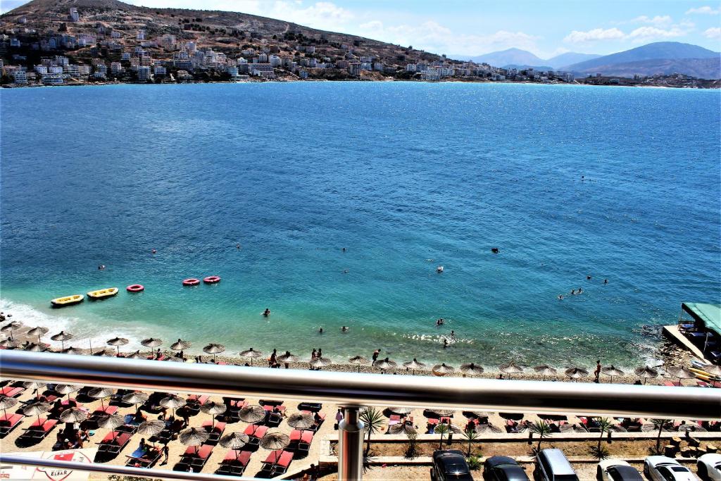 a view of a beach with people in the water at Seaside Apartment in Sarandë