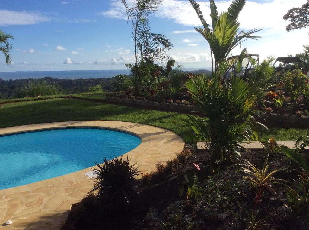 a swimming pool with a view of the ocean at Vista Villas in Ojochal
