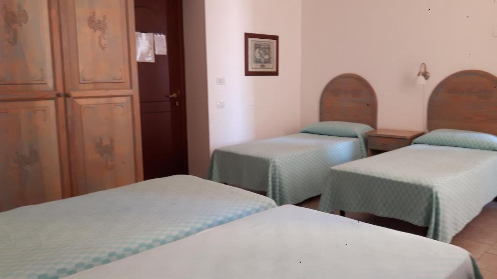 Postel nebo postele na pokoji v ubytování Alghero Vacanze Hotel