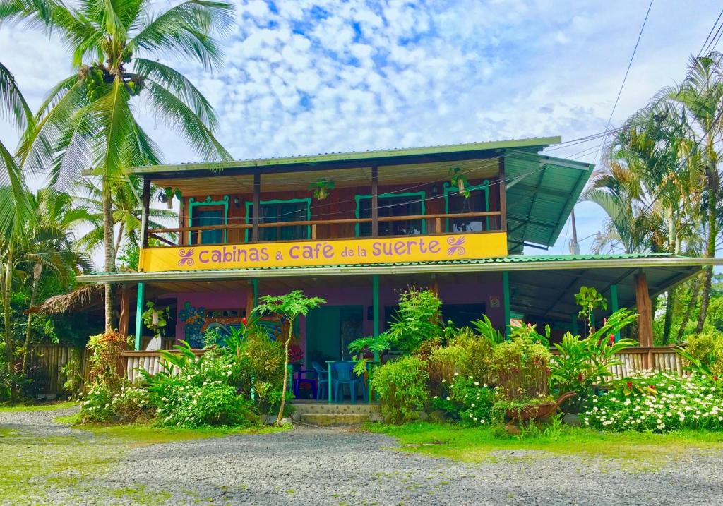 a house with a sign on the front of it at Cafe de la Suerte in Pavones