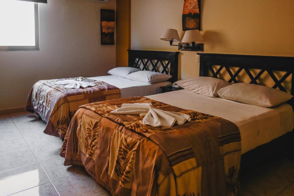 Postel nebo postele na pokoji v ubytování Hotel Plaza Mirador
