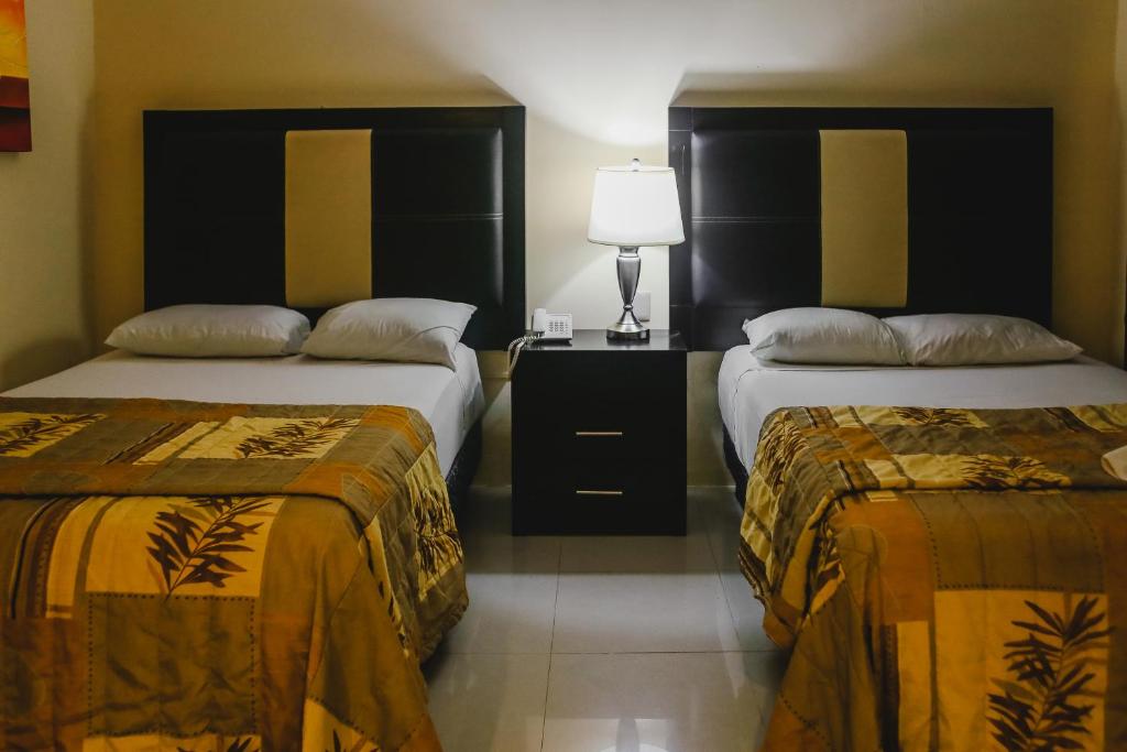 Postel nebo postele na pokoji v ubytování Hotel Plaza Mirador