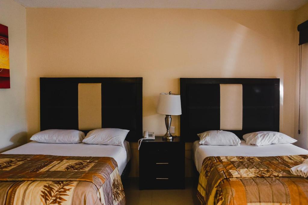 Postel nebo postele na pokoji v ubytování Hotel Plaza Mirador