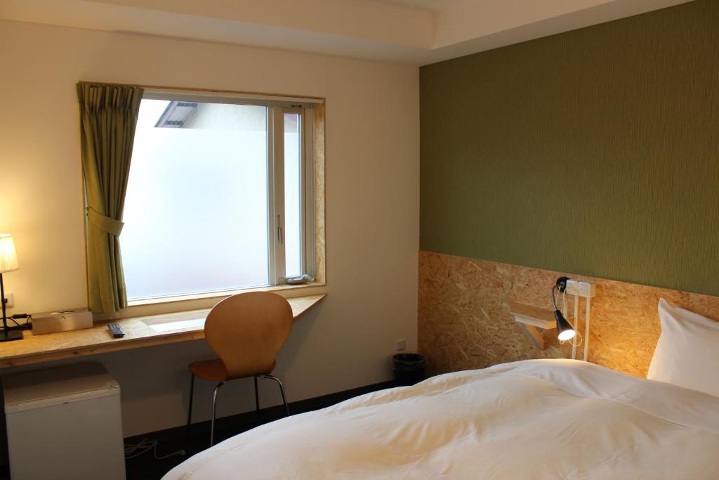 Postel nebo postele na pokoji v ubytování Nikko Station Hotel 2
