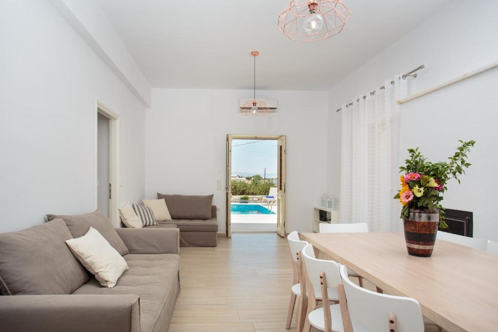 a living room with a couch and a table at Villa Evilia in Márpissa