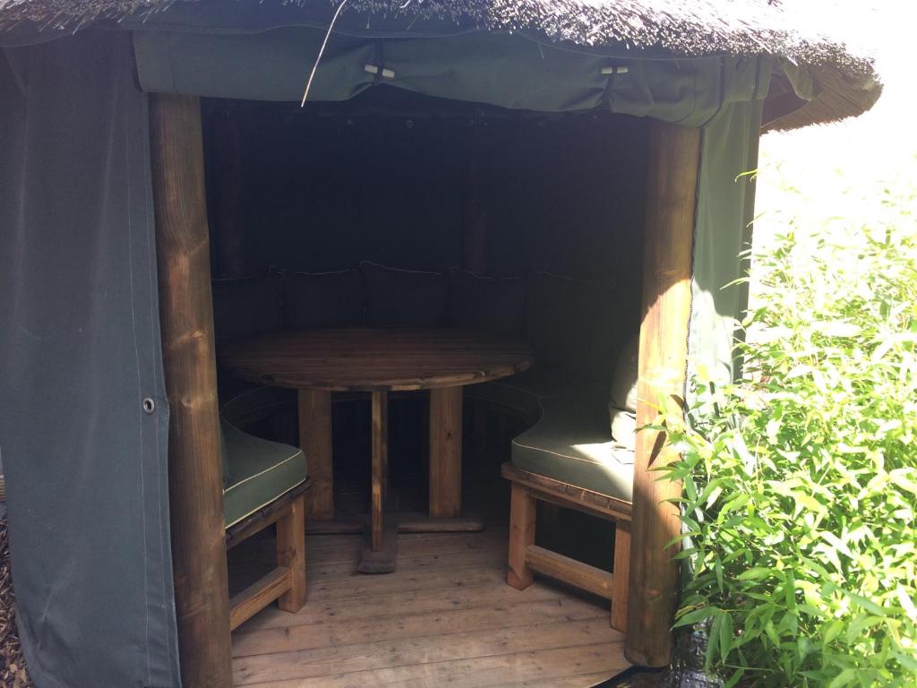 einen Tisch und zwei Stühle sowie einen Tisch und einen Regenschirm in der Unterkunft The Ashfield in Sutton in Ashfield