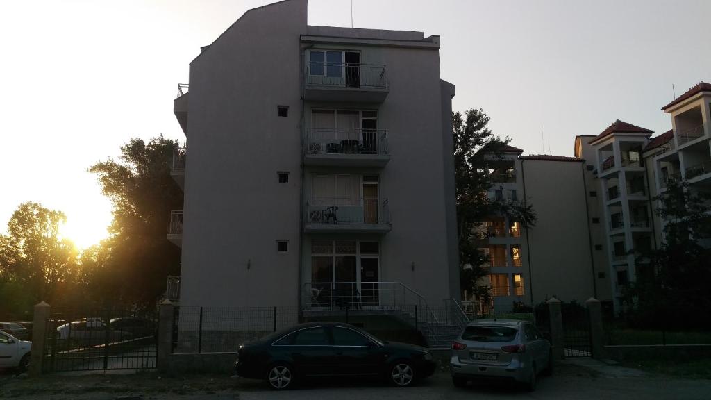 two cars parked in front of a building at Guest House Paskal in Sunny Beach