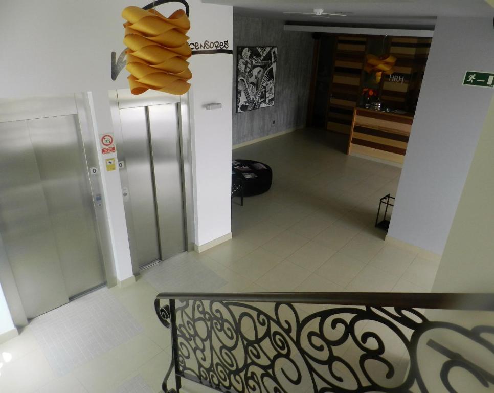 a view of a hallway with a bench in a room at Hotel Río Hortega in Valladolid