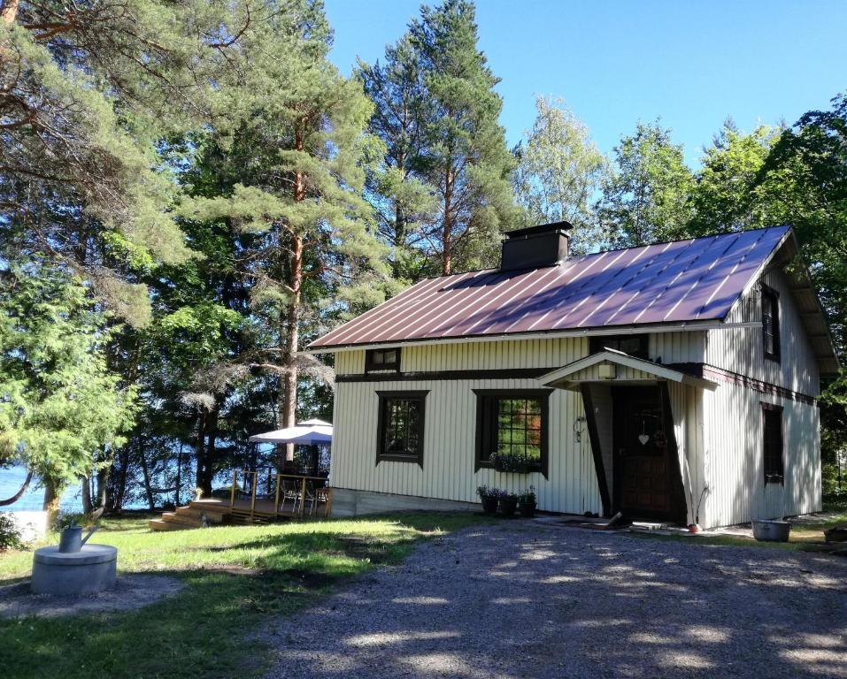 a white barn with a metal roof at Halkolanniemi in Muurame