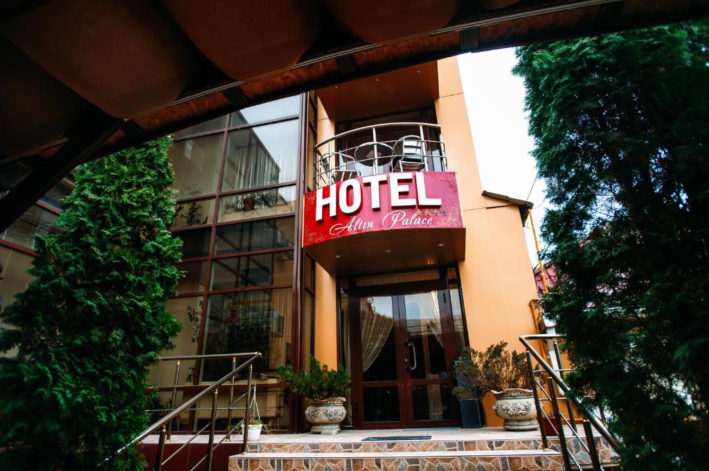 a hotel with a sign on the front of it at Altin Palace in Komrat
