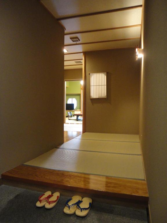 a room with two pairs of shoes on the floor at Yoshimatsu in Hakone