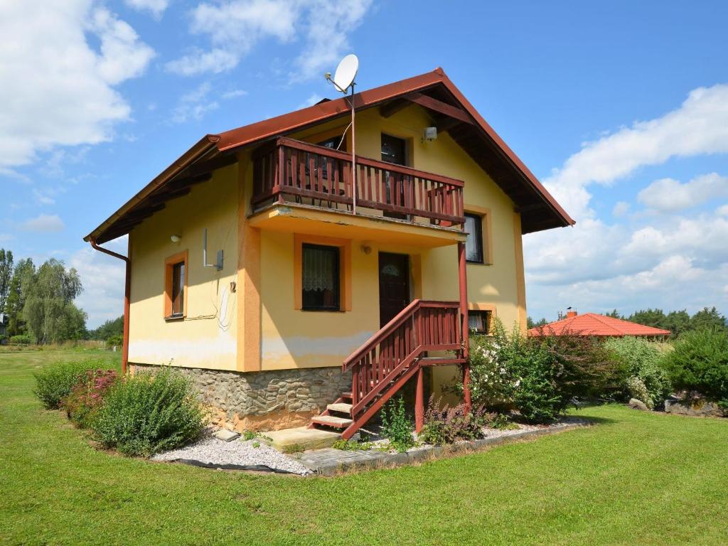 a house with a balcony on the side of it at Country House in Czech Forest with Pool in Konstantinovy Lázně