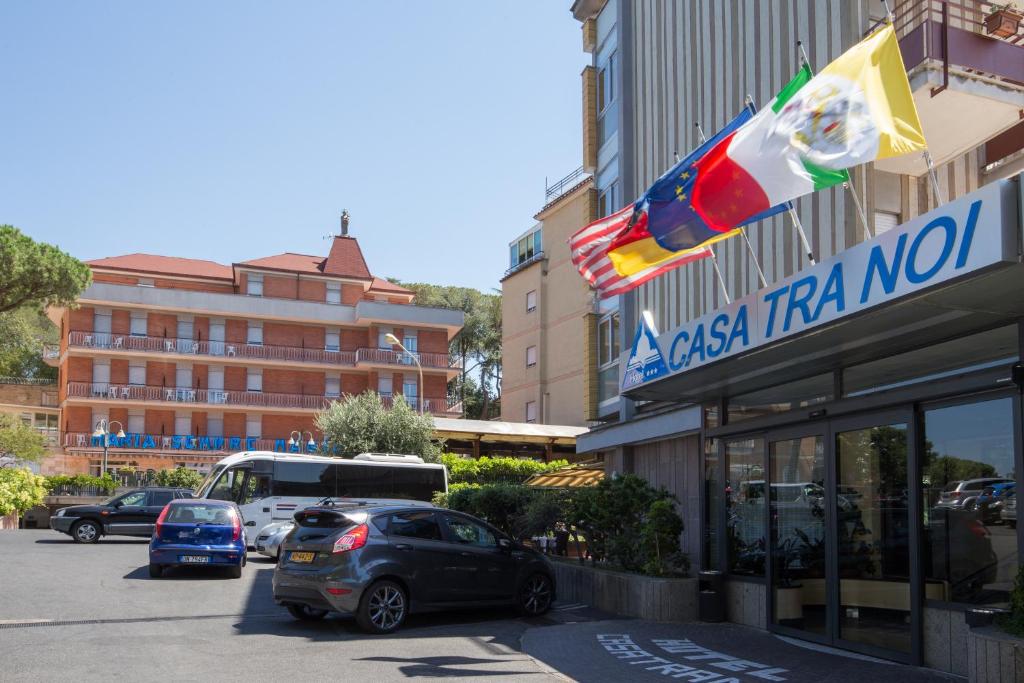 
a car parked in front of a building with a flag on it at Hotel Casa Tra Noi in Rome
