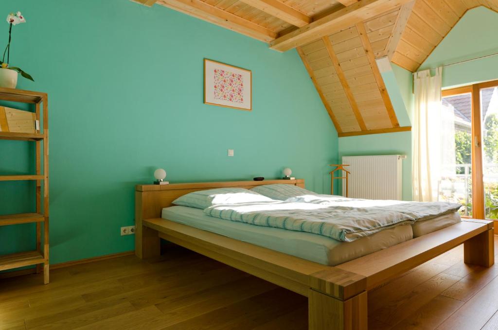 a bed in a room with a blue wall at Ferienwohnung Pforte 7 in Dalheim