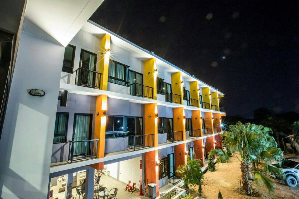 een appartementencomplex 's nachts met een auto buiten geparkeerd bij Sor Kor Sor Resort in Sattahip