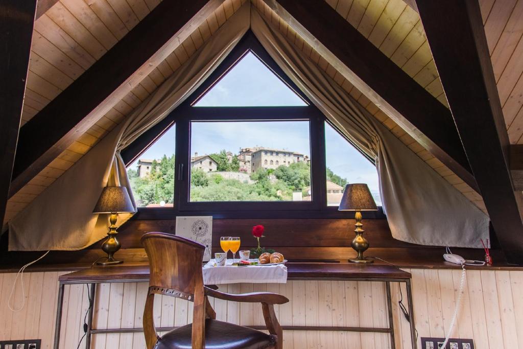 a room with a table and a chair and a window at Alojamientos Ainsa Sanchez in Aínsa