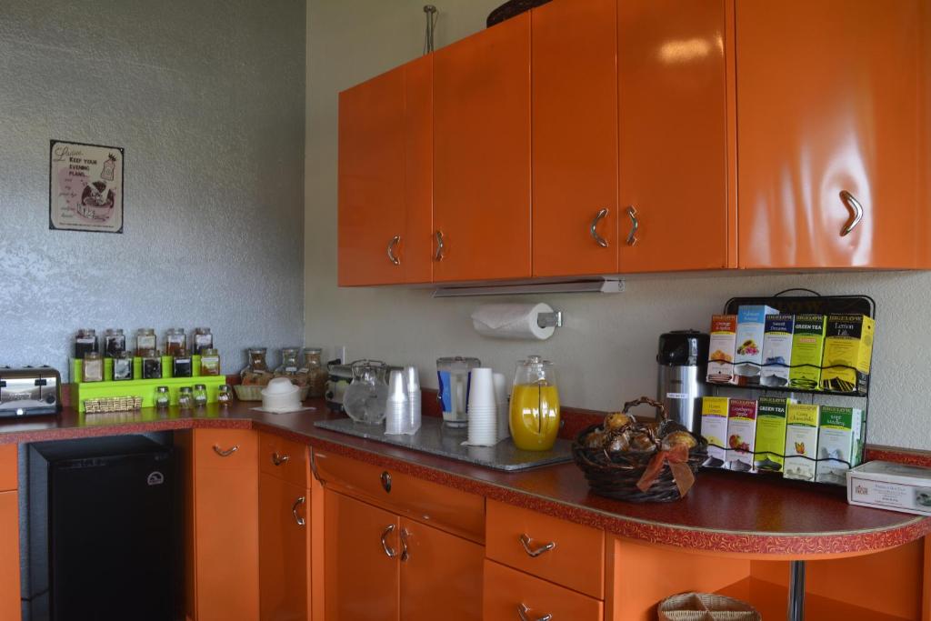 a kitchen with orange cabinets and a counter top at Retro Inn at Mesa Verde in Cortez
