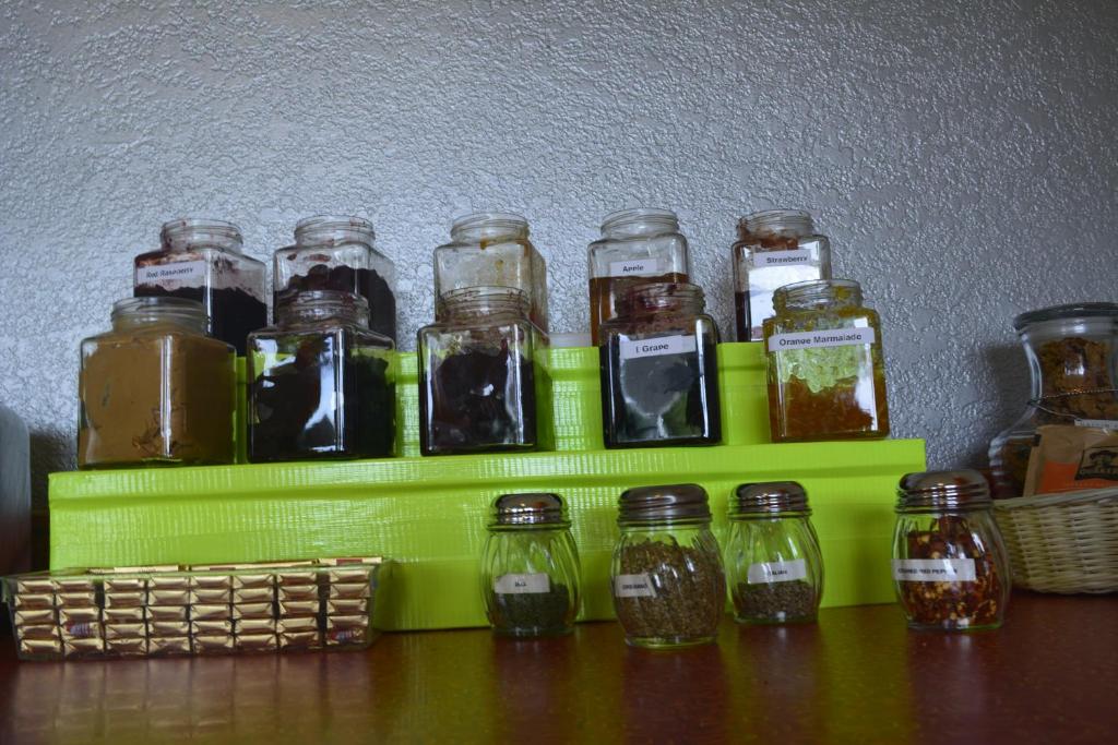 a group of jars of pickles on a green shelf at Retro Inn at Mesa Verde in Cortez