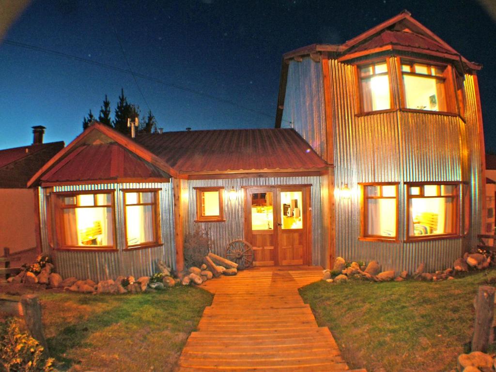a house with a pathway leading to the front door at Posada Karut Josh in El Calafate