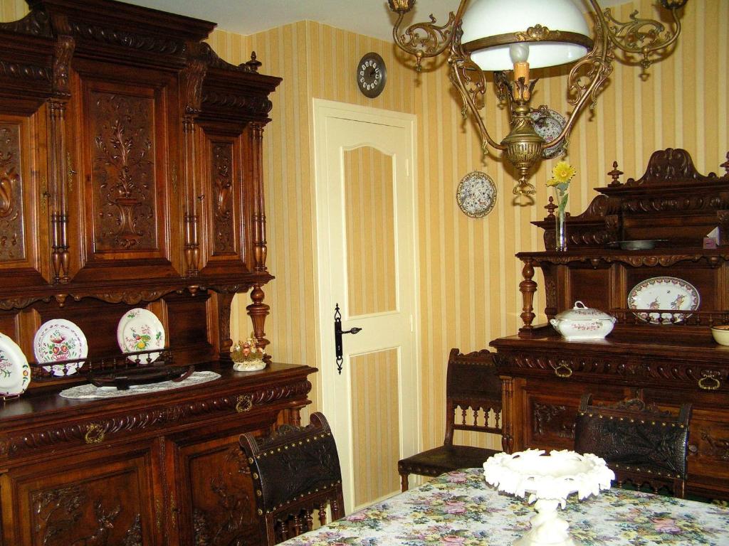 a dining room with a table and a chandelier at La Maison de Mireille in Le Puy-en-Velay