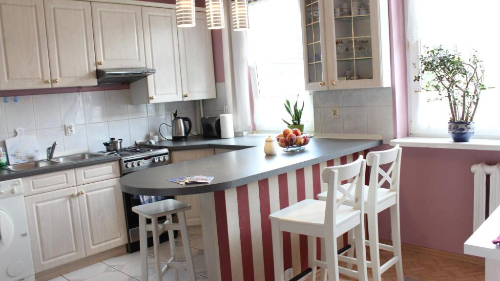 a kitchen with a red and white striped counter top at Gabriela Apartment in Poznań
