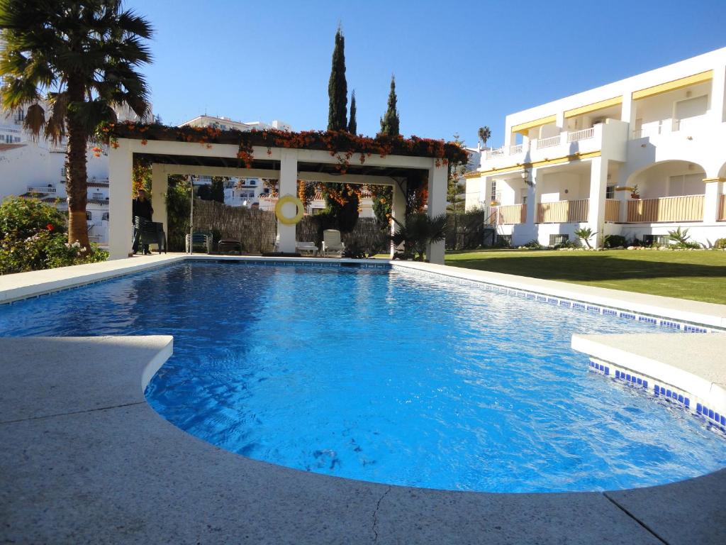 a swimming pool with a pool table in front of it at Apts Almoraide Suites - Adults Recommended in Nerja