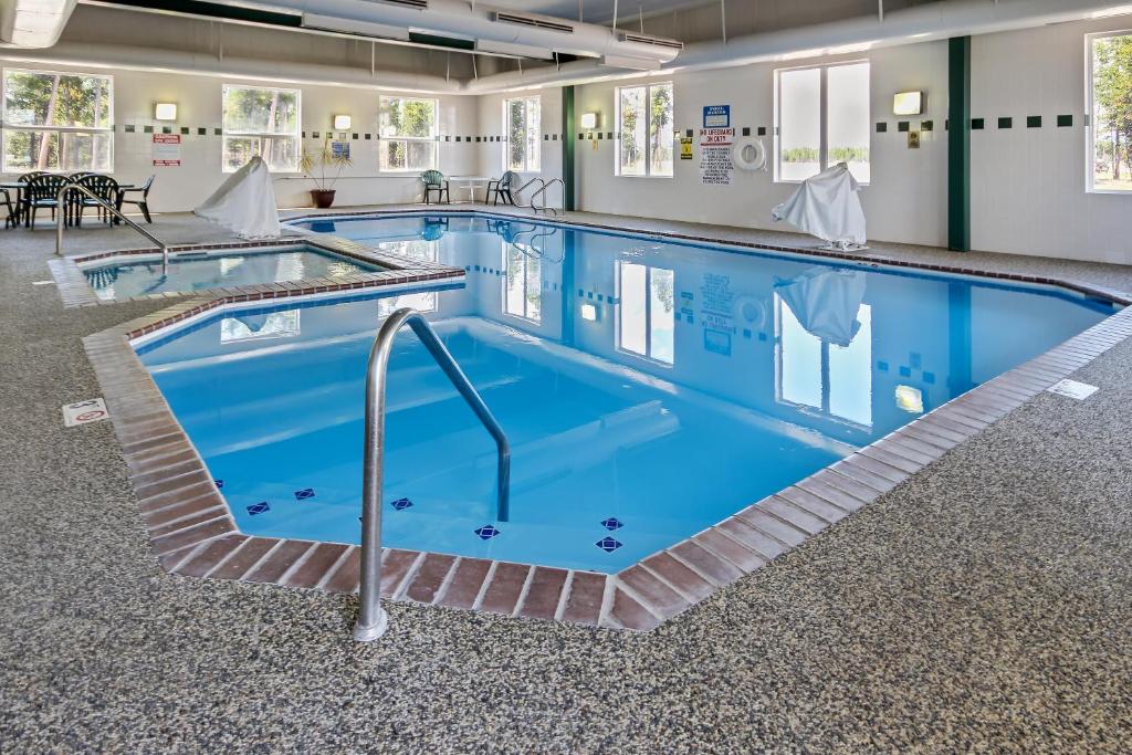 a large swimming pool with blue water at Yellowstone West Gate Hotel in West Yellowstone