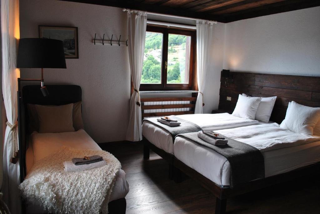 Postel nebo postele na pokoji v ubytování Hotell Millefiori- Alpine Event Lodge