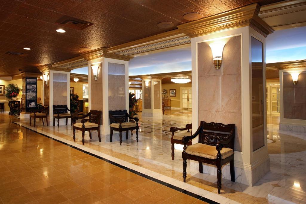 a lobby with chairs and tables in a building at The Claridge Hotel in Atlantic City