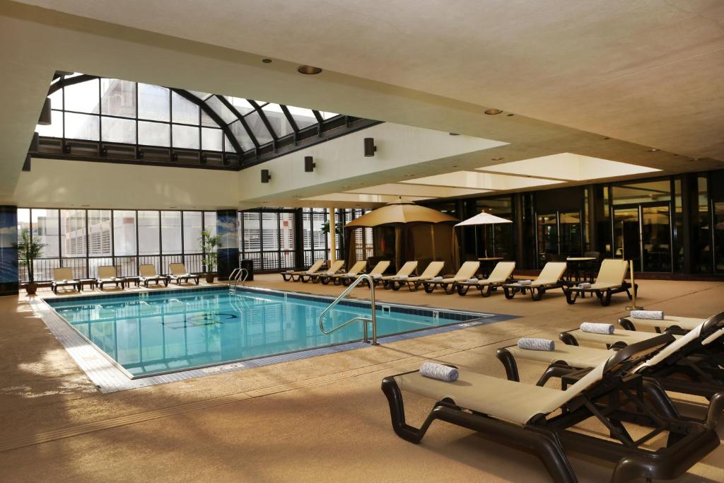 a large pool with lounge chairs and a large building at The Claridge Hotel in Atlantic City