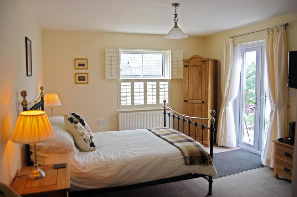 a bedroom with a bed and a large window at Highbury in Abercych