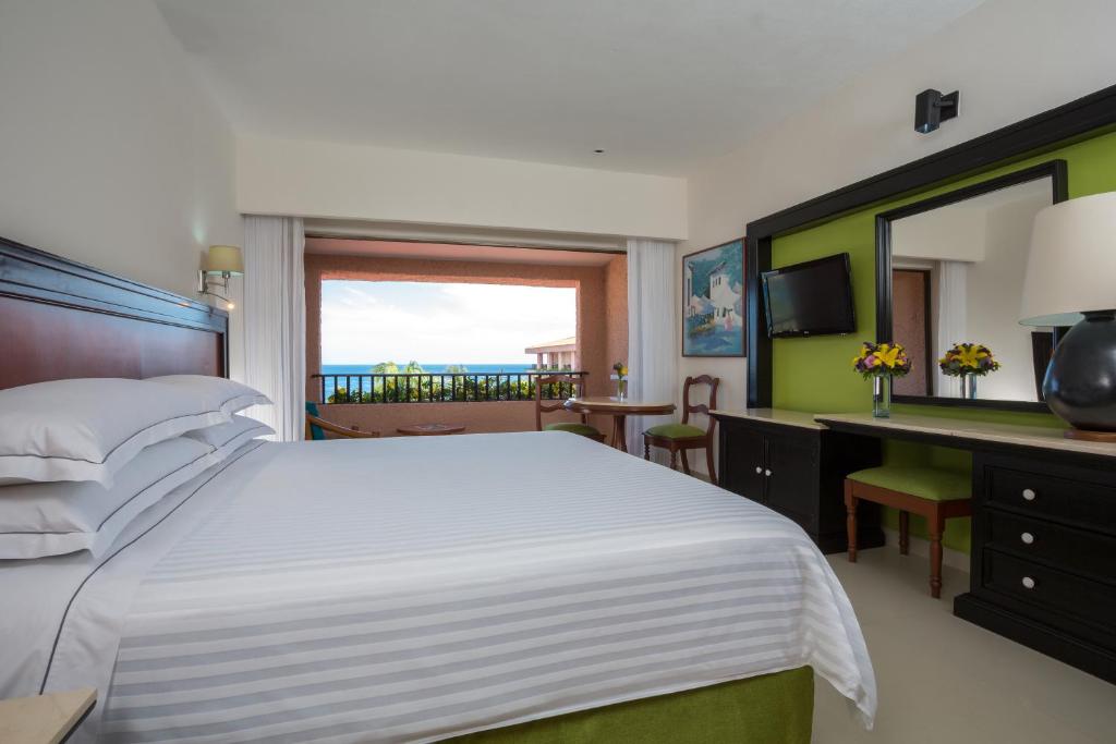 Postel nebo postele na pokoji v ubytování Barceló Huatulco - All Inclusive