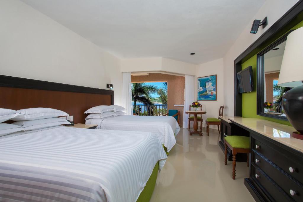 Postel nebo postele na pokoji v ubytování Barceló Huatulco - All Inclusive