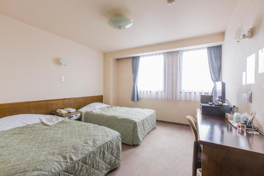 Postel nebo postele na pokoji v ubytování Hotel New Neo