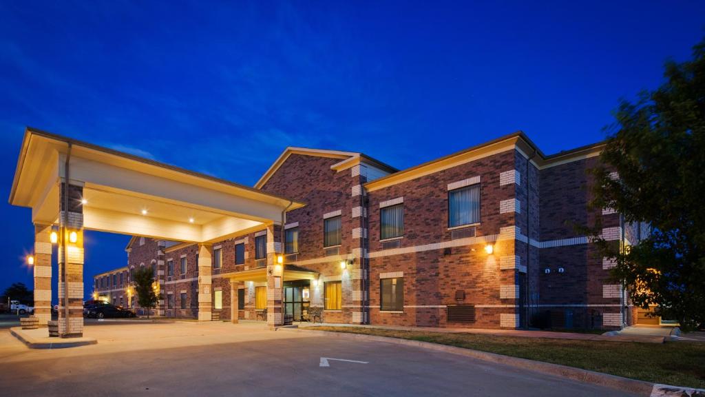 a large brick building with a parking lot at Quality Inn in Perryton