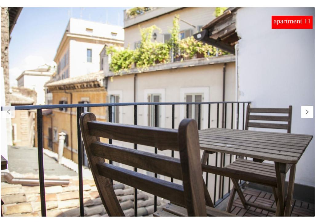 a wooden bench sitting on top of a balcony at M9 Pantheon Attic 11 in Rome