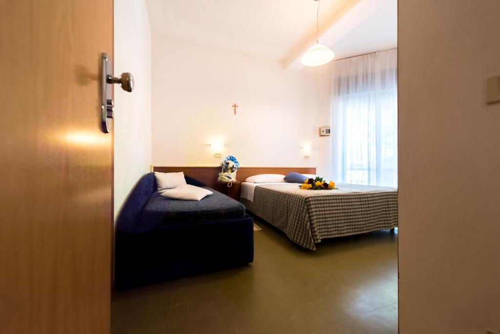 Postel nebo postele na pokoji v ubytování Hotel Lem-Casadei