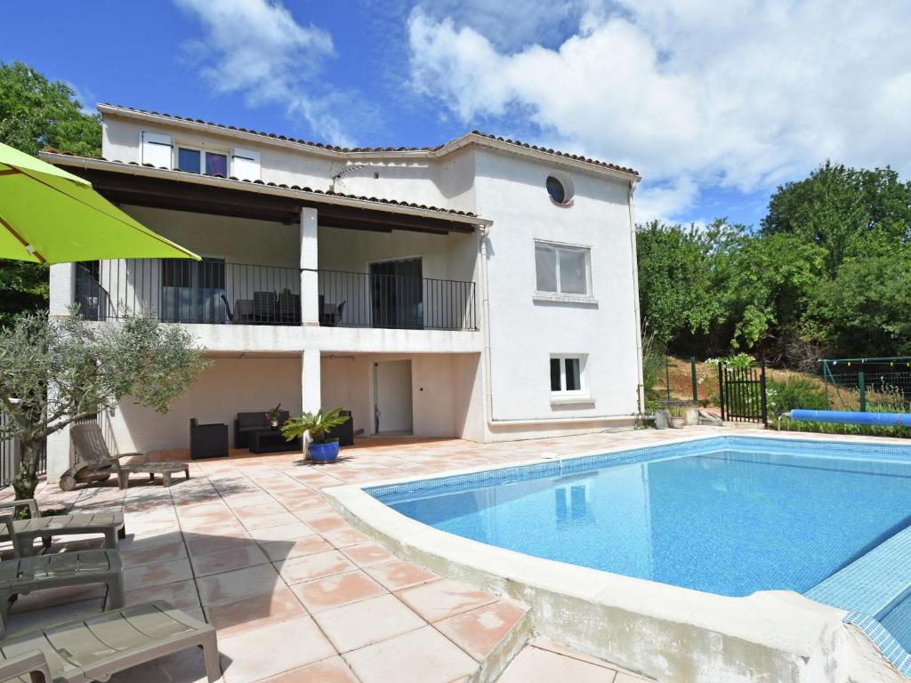 a villa with a swimming pool in front of a house at Peaceful villa with private pool in Courry