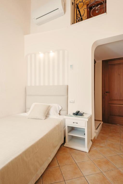 Postel nebo postele na pokoji v ubytování Hotel L'Arcangelo - Boutique Hotel