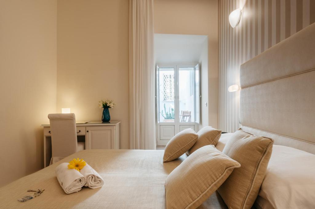 Postel nebo postele na pokoji v ubytování Hotel L'Arcangelo - Boutique Hotel