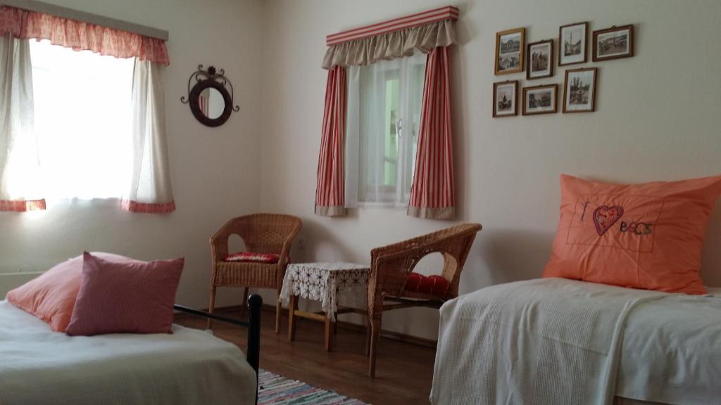 a bedroom with two beds and a table and chairs at Helló Bogács in Bogács