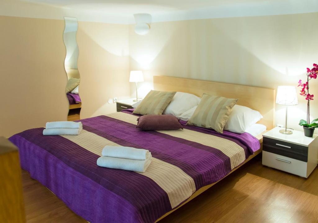 a bedroom with a large bed with towels on it at Apartment Jindrisska 25 in Prague