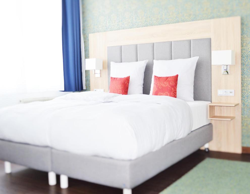 Postel nebo postele na pokoji v ubytování Pallas Hotel