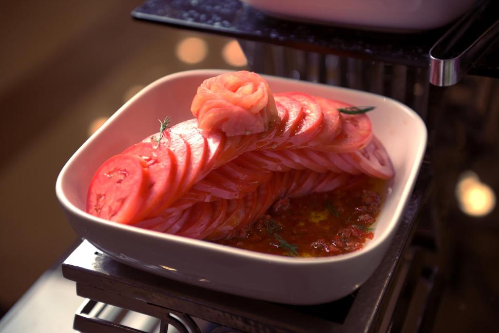 a bowl of food with tomatoes and sauce at Saja Al Madinah in Al Madinah