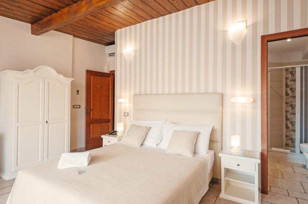 Postel nebo postele na pokoji v ubytování Hotel L'Arcangelo - Boutique Hotel