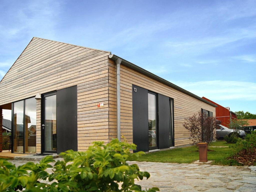 a house with large glass windows on the side of it at Bungalow Nr_2 bei Wismar _ Ostsee in Zierow