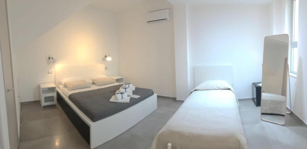 Postel nebo postele na pokoji v ubytování Corte Sveva B&B Affittacamere
