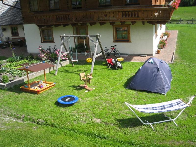 a backyard with a tent and a swing at Gratzerhof in Zederhaus